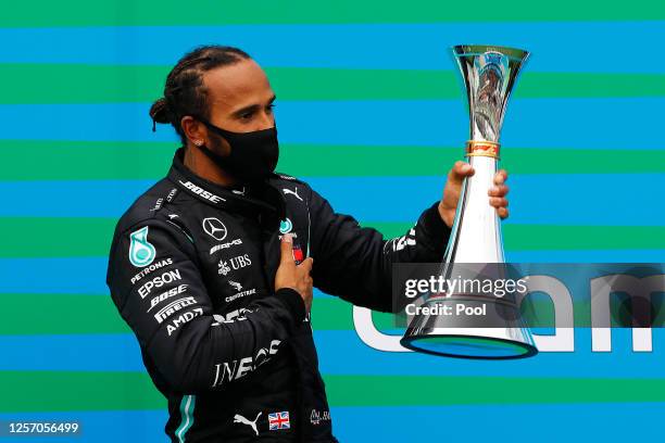 Race winner Lewis Hamilton of Great Britain and Mercedes GP celebrates on the podium after the Formula One Grand Prix of Hungary at Hungaroring on...