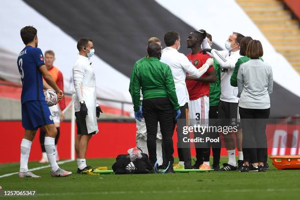 Eric Bailly of Manchester United is seen to by medical staff after a head collision during the FA Cup Semi Final match between Manchester United and...