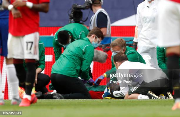 Eric Bailly of Manchester United is seen to by medical staff after a head collision and is stretchered off the pitch during the FA Cup Semi Final...