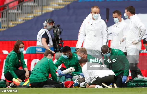 Eric Bailly of Manchester United is seen to by medical staff after a head collision and is stretchered off the pitch during the FA Cup Semi Final...