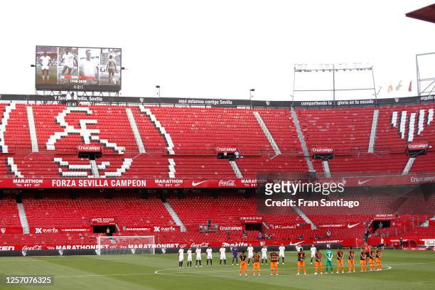Both teams stand for a minutes silence in memory of Biri Biri during the Liga match between Sevilla FC and Valencia CF at Estadio Ramon Sanchez...