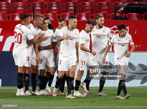 Sergio Reguilon of Sevilla FC celebrates with teammates after scoring his sides first goal during the Liga match between Sevilla FC and Valencia CF...