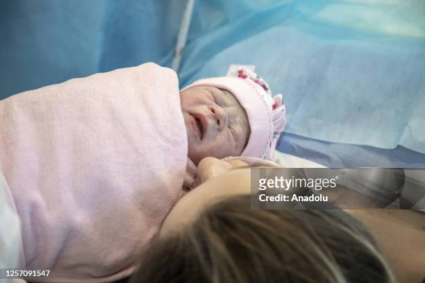 Olga, 30-years-old, kisses her newborn child in the labor room after she gave her birth in the maternity section of the 1st City Maternity Hospital...