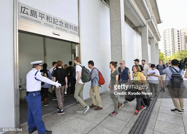 Visitors enter the Hiroshima Peace Memorial Museum on May 22 after it reopened to the public after temporarily closing during the three-day Group of...