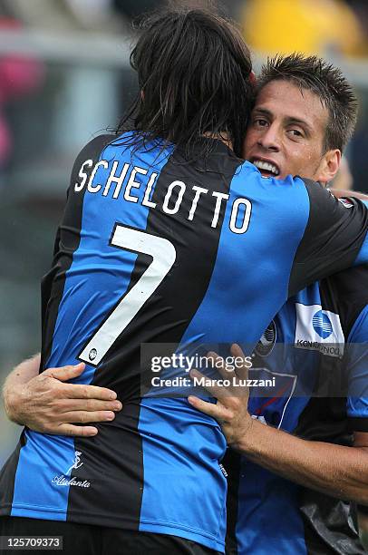 Ezequiel Schelotto and German Denis of Atalanta BC celebrate victory at the end of the Serie A match between Atalanta BC and US Citta di Palermo at...