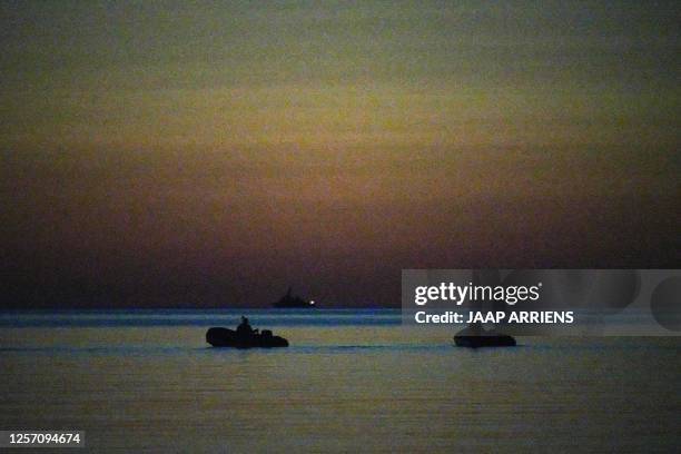Royal Marines on rubberboats with night vision devices approach the shore for a beach landing as part of the NATO Spring Storm exercises in...