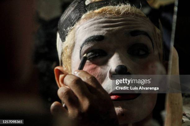 Performer from Circus Estoril puts on makeup before a night of drive-in performance amidst the coronavirus pandemic on July 18, 2020 in Itaguai,...