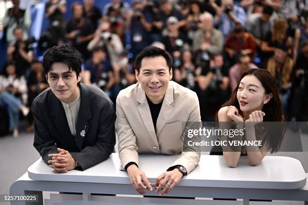 Chinese actor Liu Haoran, Singaporean director Anthony Chen and Chinese actress Zhou Dongyu pose during a photocall for the film "Ran Dong" at the...