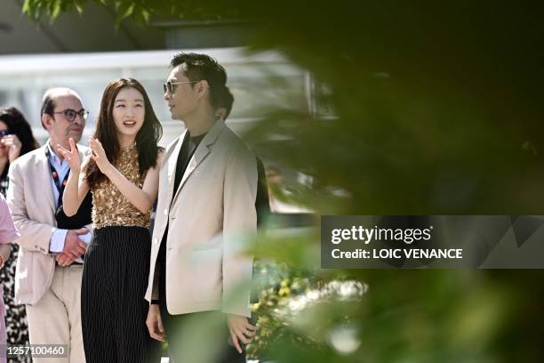 Chinese actress Zhou Dongyu and Singaporean director Anthony Chen arrive to attend a photocall for the film "Ran Dong" at the 76th edition of the...