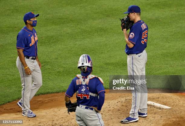 Manager Luis Rojas of the New York Mets pulls starting pitcher Corey Oswalt in the fourth inning against the New York Yankees as catcher Rene Rivera...