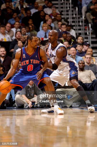 Latrell Sprewell of the New York Knicks handles the ball against Michael Jordan of the Washington Wizards at the MCI Center on December 13, 2001 in...