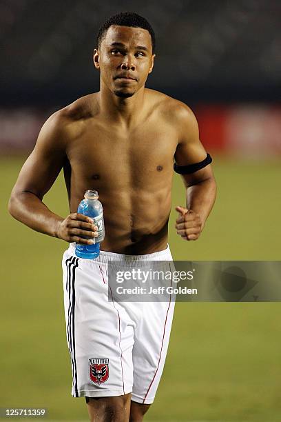 Charlie Davies of D.C. United walks shirtless off the field after the victory against Chivas USA at The Home Depot Center on September 10, 2011 in...