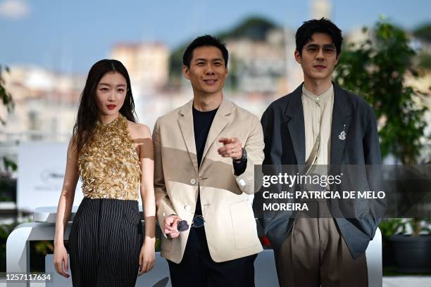 Chinese actress Zhou Dongyu, Singaporean director Anthony Chen and Chinese actor Liu Haoran pose during a photocall for the film "Ran Dong" at the...