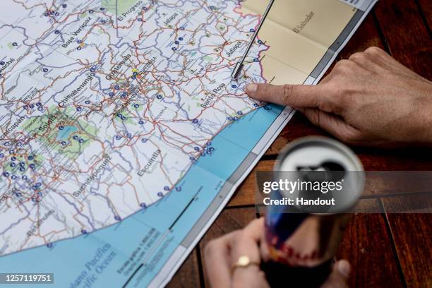 In this handout image provided by Red Bull, Rhiannan Iffland of Australia points to a spot on a map while discussing plans at the Rio Dulce during...