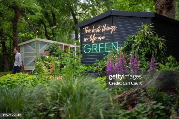 Man walks past displays at the Chelsea Flower Show on May 22, 2023 in London, England. The Chelsea Flower Show, also known as the Great Spring Show,...