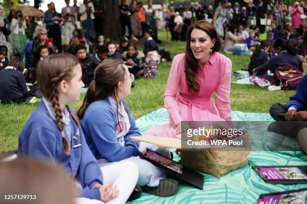 Catherine, Princess of Wales speaks to pupils from schools as she takes part in the first Children's Picnic at the RHS Chelsea Flower Show, at the...