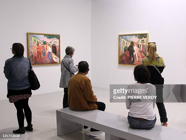 Visitors look at Munch's paintings at the Centre Pompidou modern art museum, also known as the 'Centre Beaubourg', during the Edvard Munch exhibition...