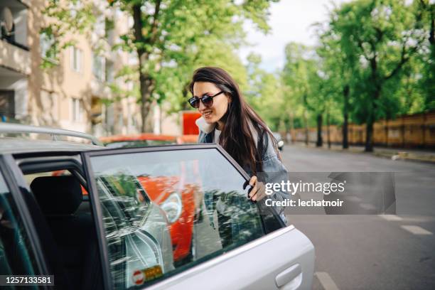 young woman taking a car share ride on the streets of berlin - car passenger stock pictures, royalty-free photos & images