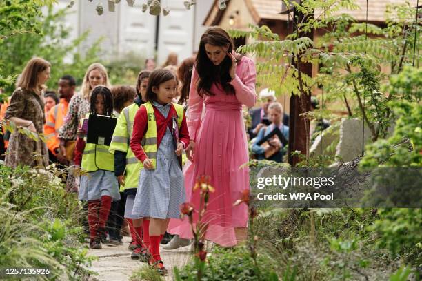 Catherine, Princess of Wales talks with pupils, after taking part in the first Children's Picnic at the RHS Chelsea Flower Show, at the Royal...