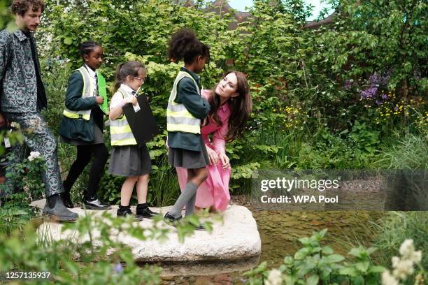 Catherine, Princess of Wales talks with pupils, after taking part in the first Children's Picnic at the RHS Chelsea Flower Show, at the Royal...