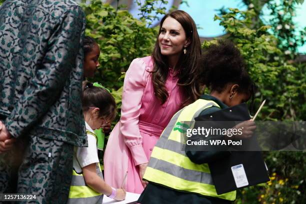 Catherine, Princess of Wales talks with pupils, after taking part in the first Children's Picnic at the RHS Chelsea Flower Show, at the Royal...
