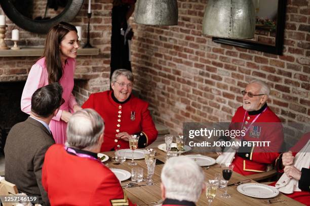 Britain's Catherine, Princess of Wales speaks to the Chelsea Pensioners after joining school children taking part in the first Children's Picnic on...