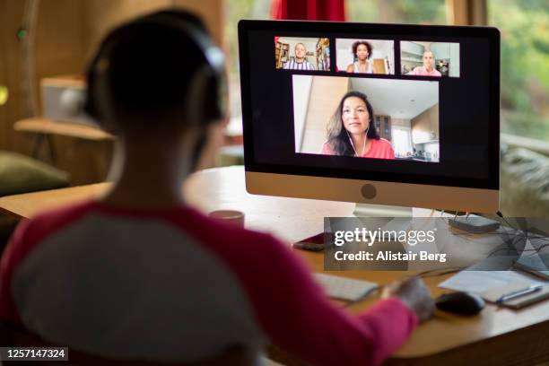 mixed race man working from home on his computer during lockdown - speech pathology stock pictures, royalty-free photos & images