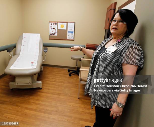 Program manager Peggy Castanie points out a bariatric exam table which can accommodate heavier patients at the UTMB Multispecialty Center and Stark...