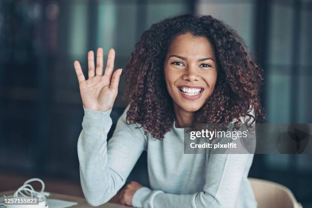 beautiful young african ethnicity woman - raising hand stock pictures, royalty-free photos & images