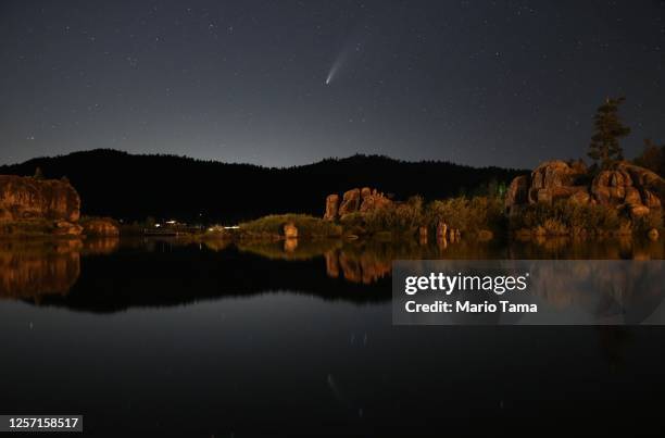 Comet NEOWISE, also known as 'C/2020 F3', is visible above Big Bear Lake after sunset on July 19, 2020 in Big Bear Lake, California. The comet is...