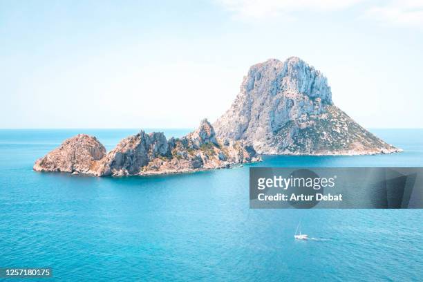 the nature reserve of es vedra island in front ibiza coast with beautiful blue colors. el paisaje de ibiza con la isla de es vedra. - es vedra stock pictures, royalty-free photos & images