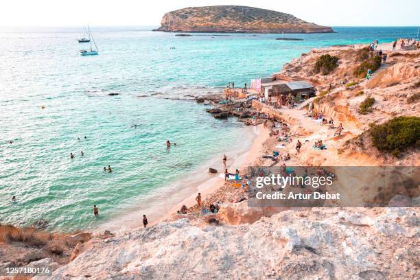 paradise beach in ibiza island during sunset. - ibiza island stock pictures, royalty-free photos & images