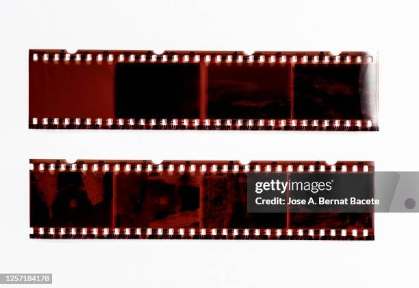 color negative 35mm film stripes on a white background. - film reel stock pictures, royalty-free photos & images