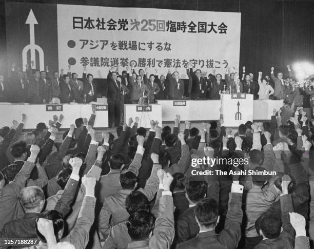 Japan Socialist Party chairman Kozo Sasaki and party members raise their fists during the 25th party convention on May 6, 1965 in Tokyo, Japan.