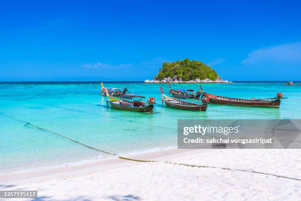 longtail boats on beach against sky at koh lipe island, thailand, asia - ko lipe stock pictures, royalty-free photos & images