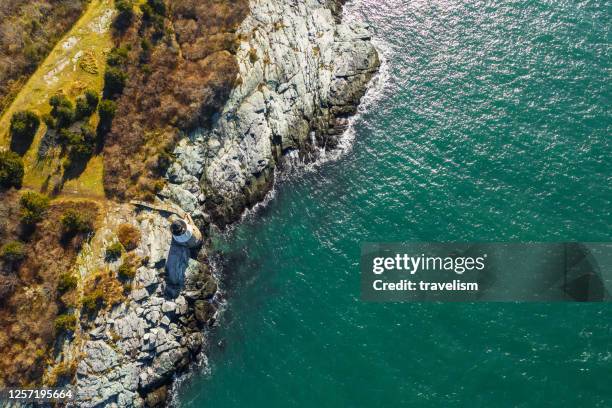 drone aerial view of sunset in newport rhode island at castle hill lighthouse - boat top view stock pictures, royalty-free photos & images