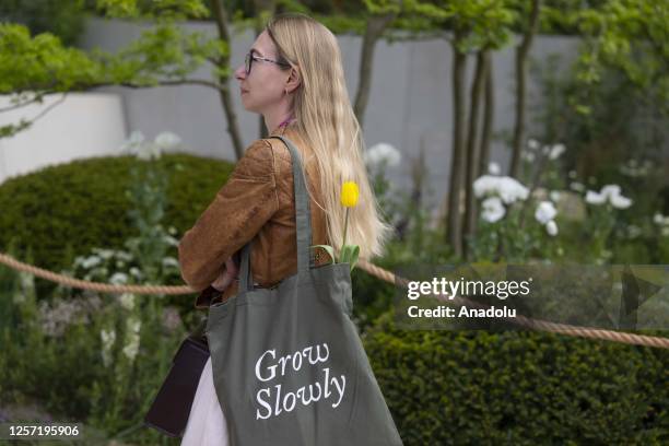 Woman looks on as Catherine, Princess of Wales attends press day event held within the RHS Chelsea Flower Show at the Royal Hospital Chelsea in...