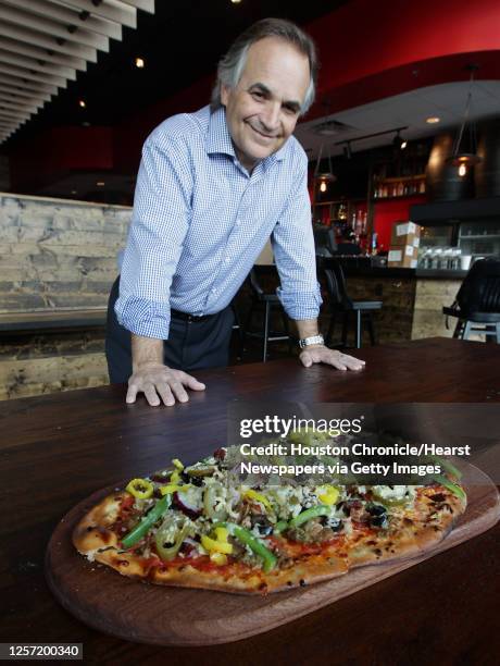 City Oven Co-owner Larry Martin with the City Oven Supreme pizza, San Marzano style tomato sauce, pepperoni, sausage, meatball, applewood bacon, baby...