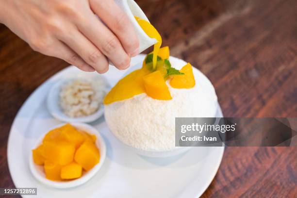 fresh summer cool, cold dessert, mango shaved ice, bingsu or patbingsu - mango shaved ice stock pictures, royalty-free photos & images