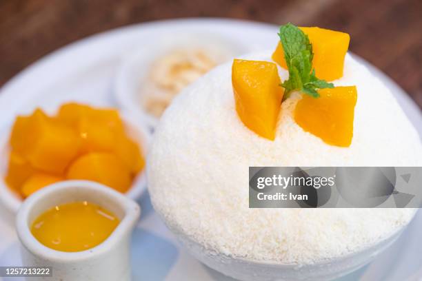 fresh summer cool, cold dessert, mango shaved ice, bingsu or patbingsu - mango shaved ice stock pictures, royalty-free photos & images