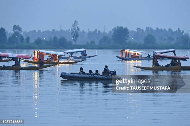 Delegates are being escorted by Indian Navy's Marine Commandos as they take shikara ride in the Dal Lake after attending the G20 tourism meeting in...