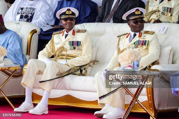 Outgoing Nigerian President Muhammadu Buhari looks on with the Chief of Naval Staff, Vice Admiral Awwal Zubairu Gambo at the presidential fleet...