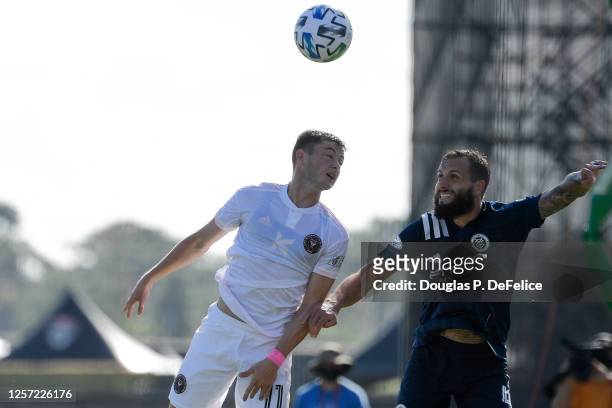 Matias Pellegrini of Inter Miami CF and Maxime Chanot of New York City FC fight for a header during the first half in the MLS is Back Tournament at...