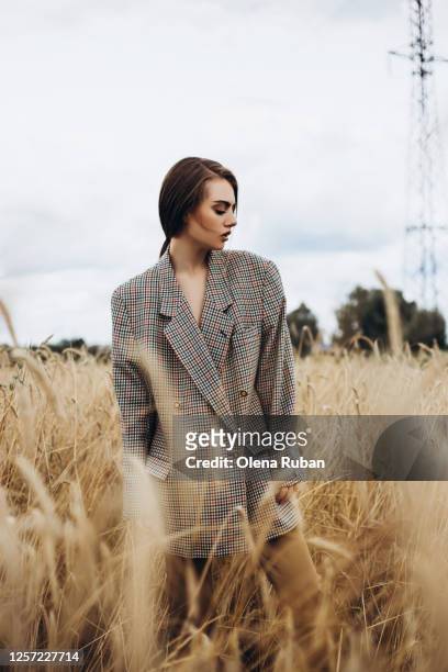beautiful young stylish woman in plaid jacket - coat check stock pictures, royalty-free photos & images