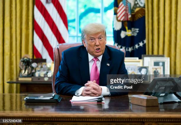 President Donald Trump talks to reporters while hosting Republican Congressional leaders and members of his cabinet in the Oval Office at the White...