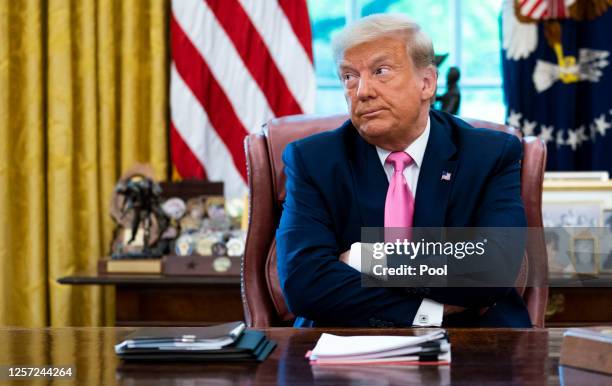 President Donald Trump talks to reporters while hosting Republican Congressional leaders and members of his cabinet in the Oval Office at the White...