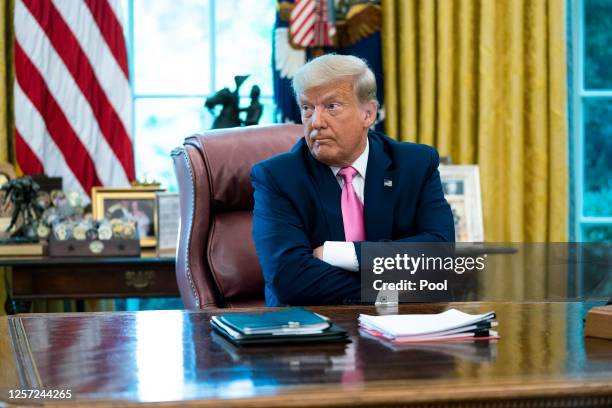 President Donald Trump talks to reporters while hosting Republican Congressional leaders and members of his cabinet in the Oval Office at the White...