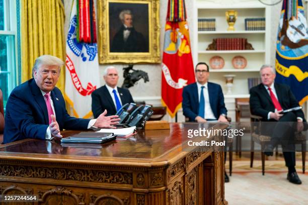 President Donald Trump talks to reporters while hosting Vice President Mike Pence, Treasury Secretary Steven Mnuchin, White House Chief of Staff Mark...