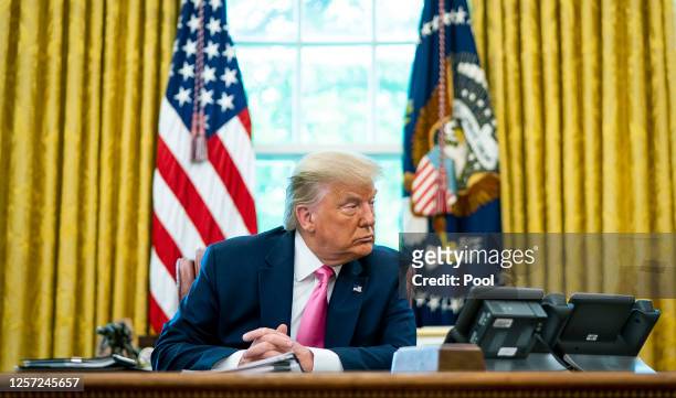 President Donald Trump talks to reporters while hosting Republican Congressional leaders and members of his cabinet in the Oval Office at the White...