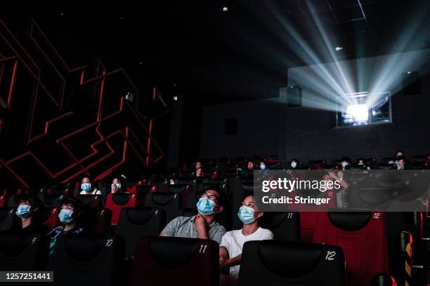 Residents watch a movie in a cinema in Wuhan on July 20, 2020 in Wuhan ,Hubei Province,China.Taking various measures against COVID-19, cinemas in the...